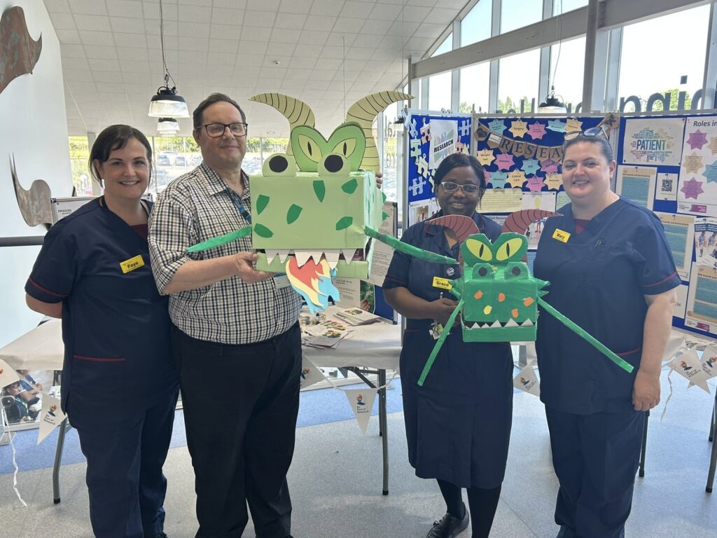 Photograph of research colleagues at the Research Showcase at Heartlands Hospital.