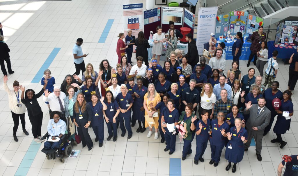 Photograph of research colleagues at the Research Showcase at Queen Elizabeth Hospital Birmingham.