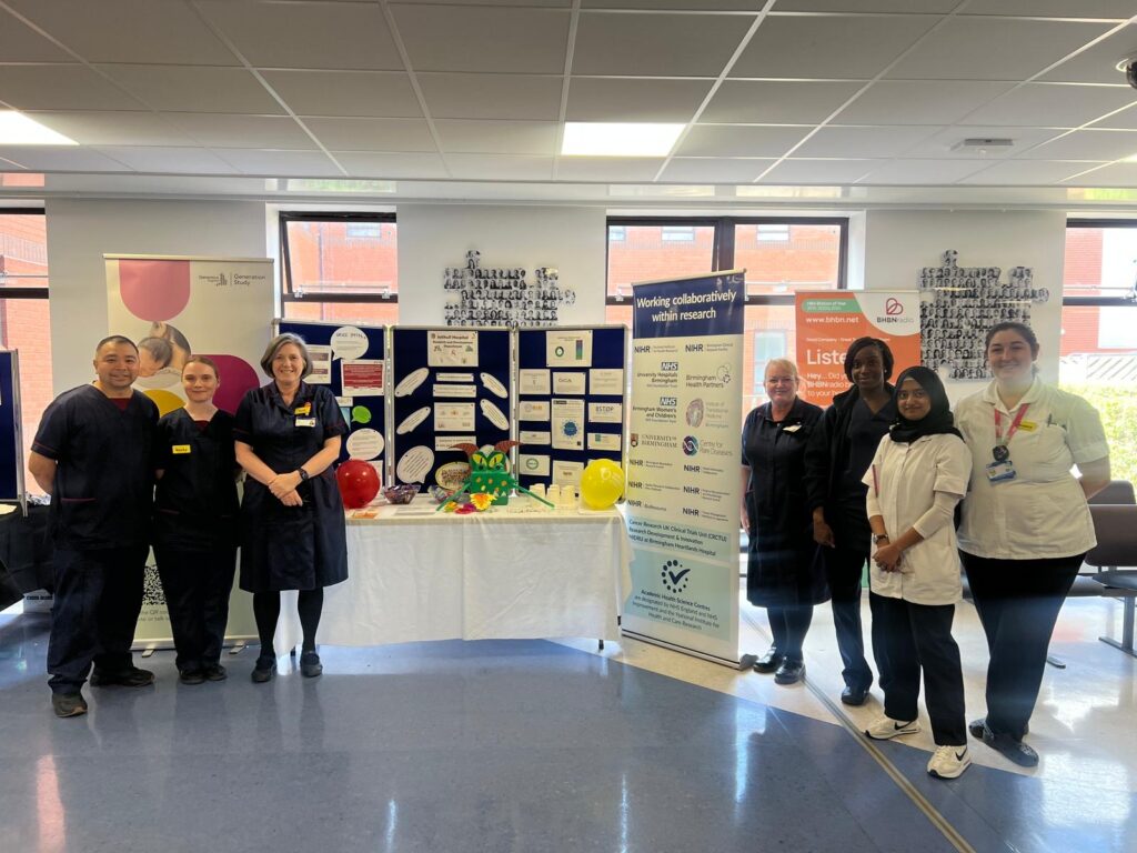 Photograph of research colleagues at the Research Showcase at Solihull Hospital.