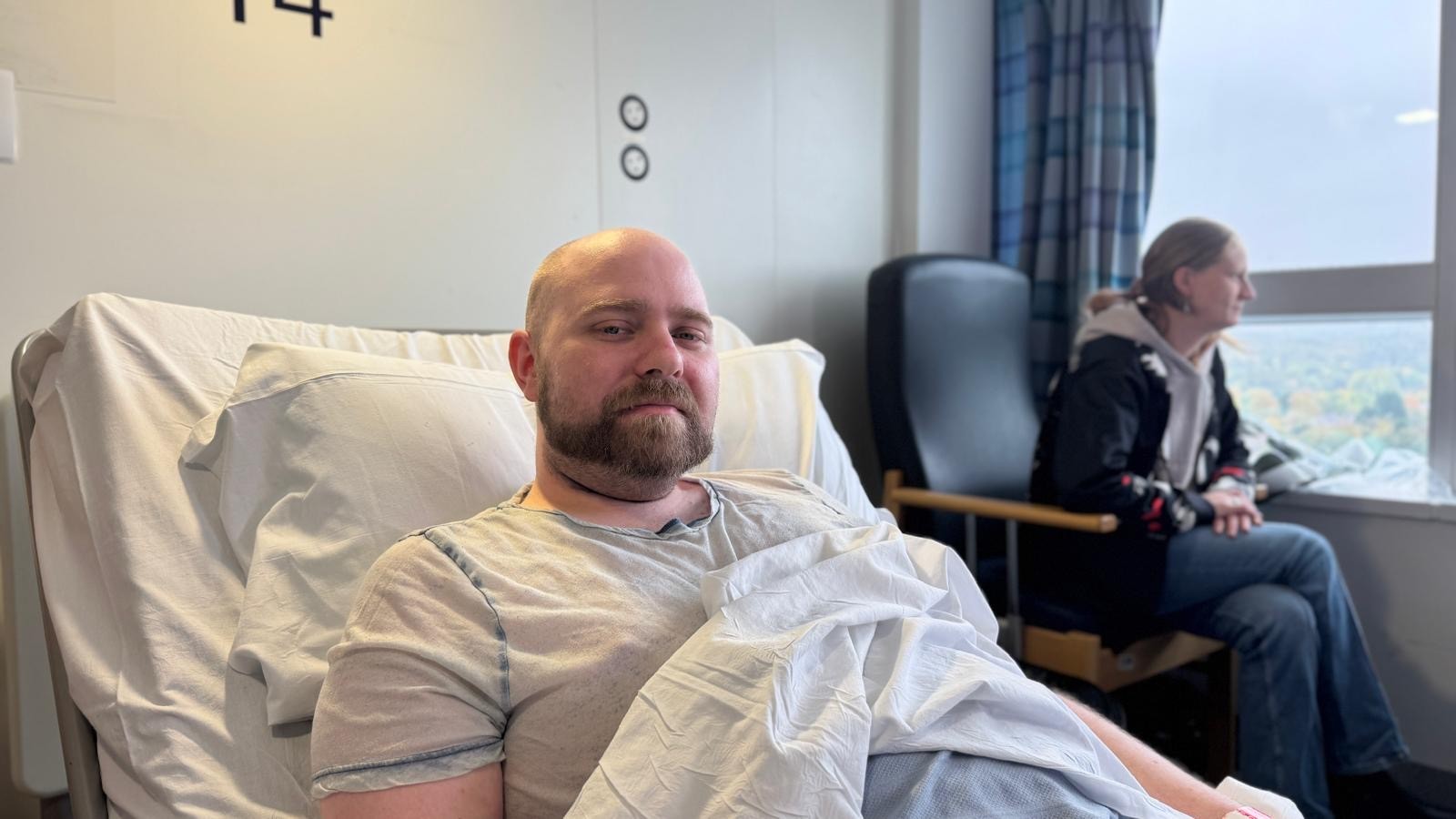 A man sat up in a hospital bed